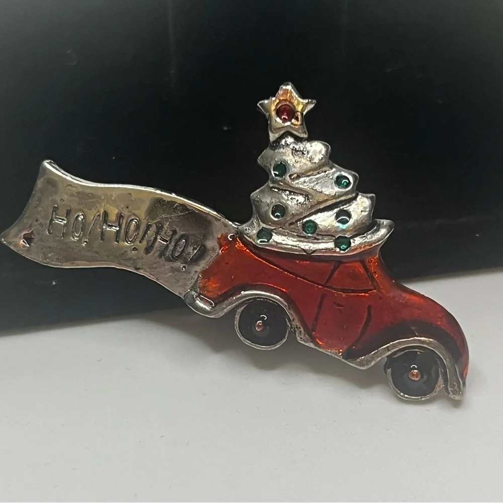 Vintage Christmas brooch, metal and enamel. There’s a dark spot on the Ho Ho Ho